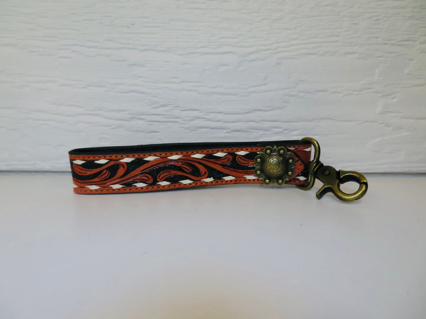 Black with brown and white buck stitching and concho