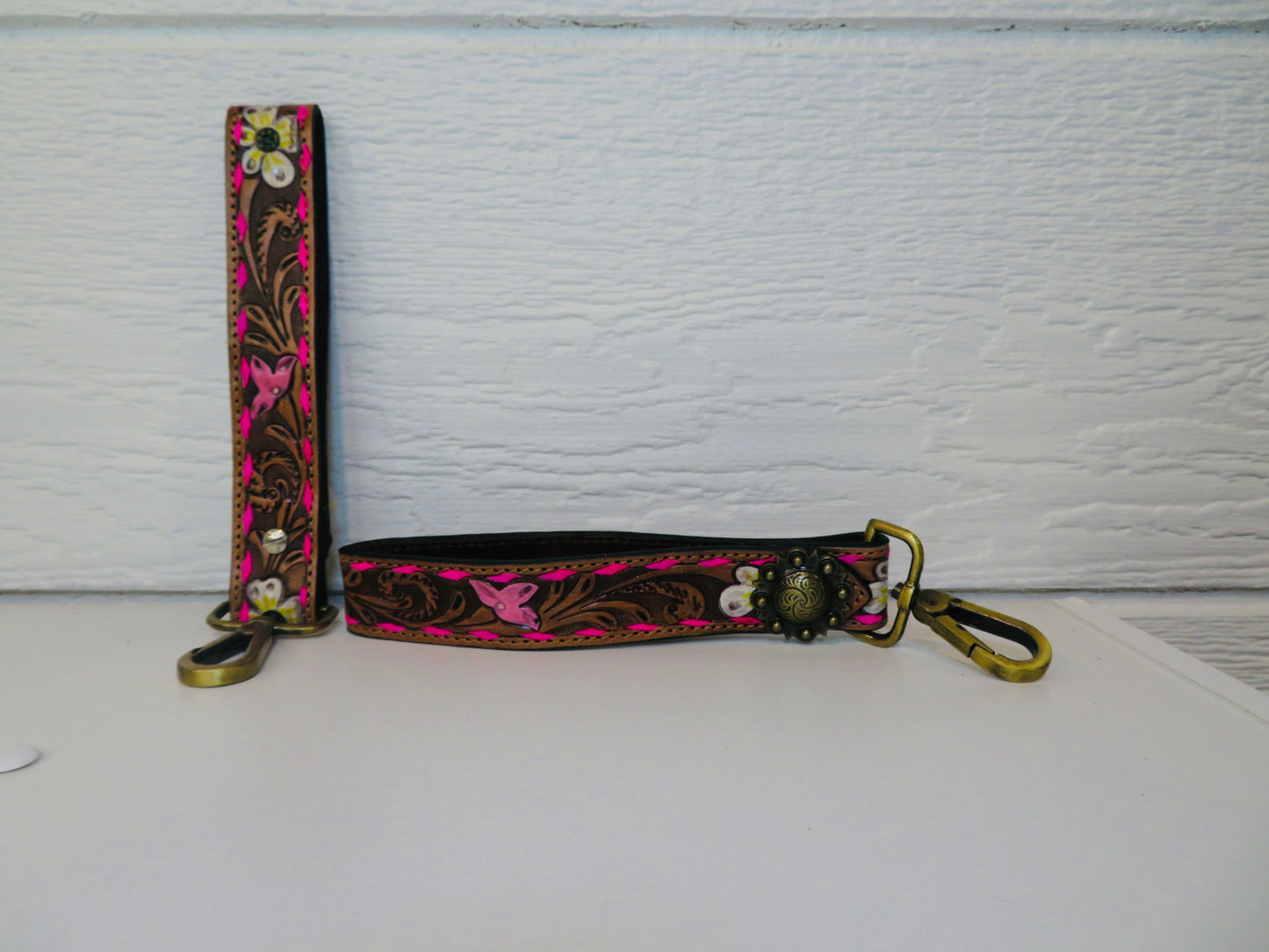 Brown with hot pink buck stitching with concho and painted flowers