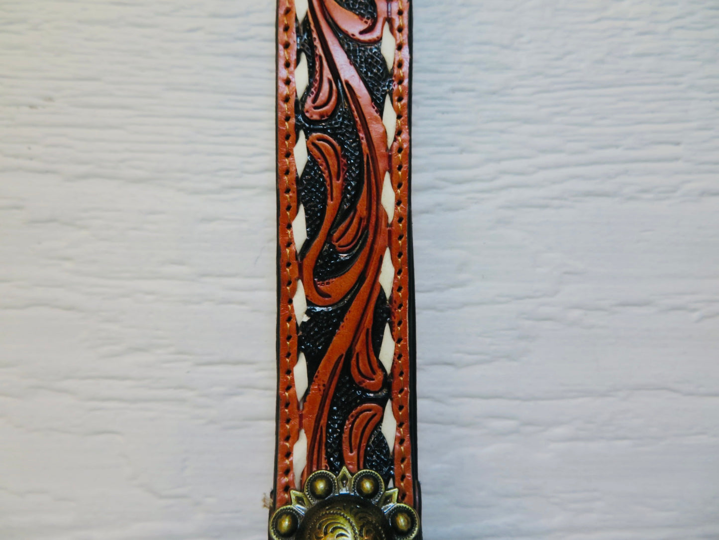 Black with brown and white buck stitching and concho