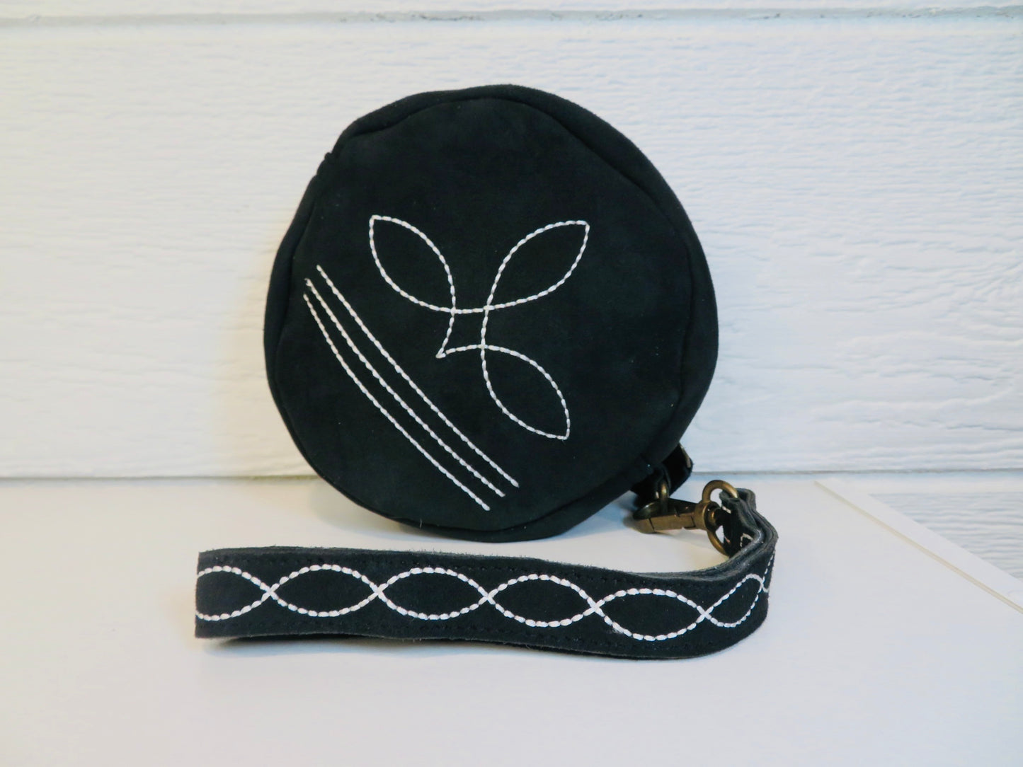 Black bootstitch wristlet