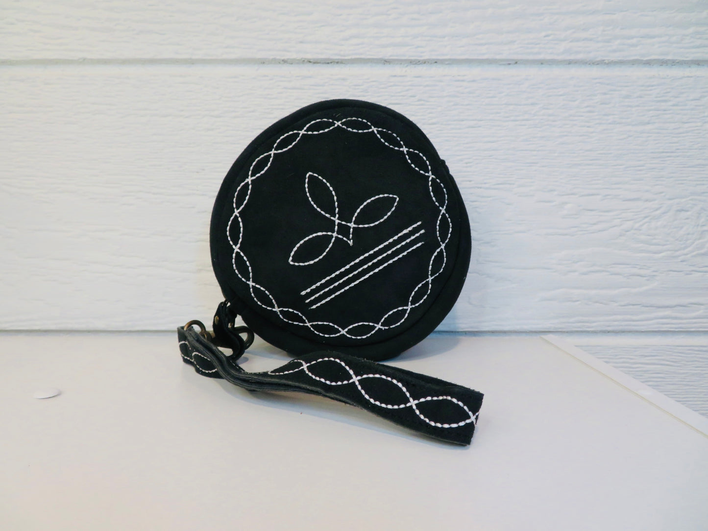Black bootstitch wristlet